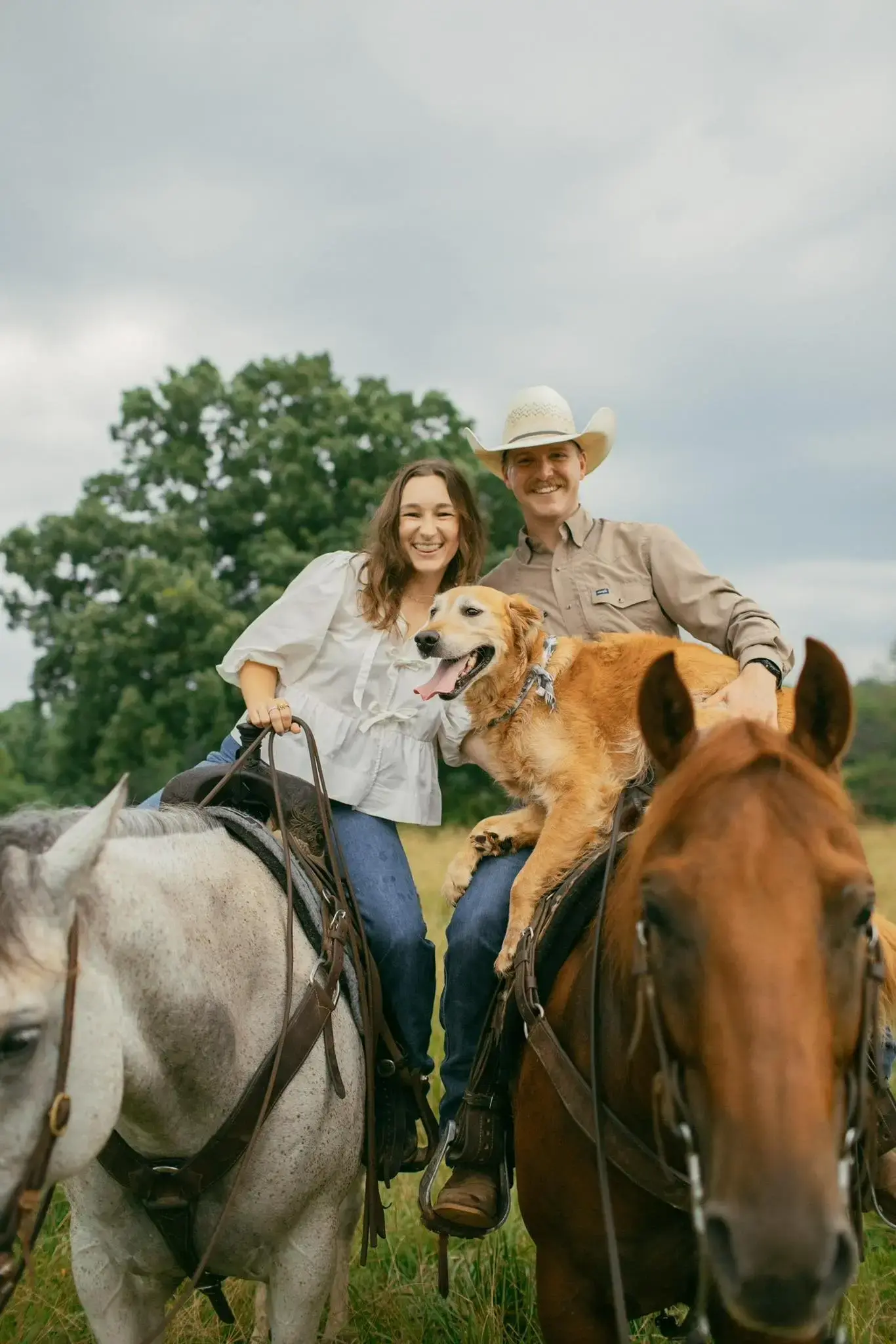 Jordan Shore standing with Kelsey beside a horse at the training facility